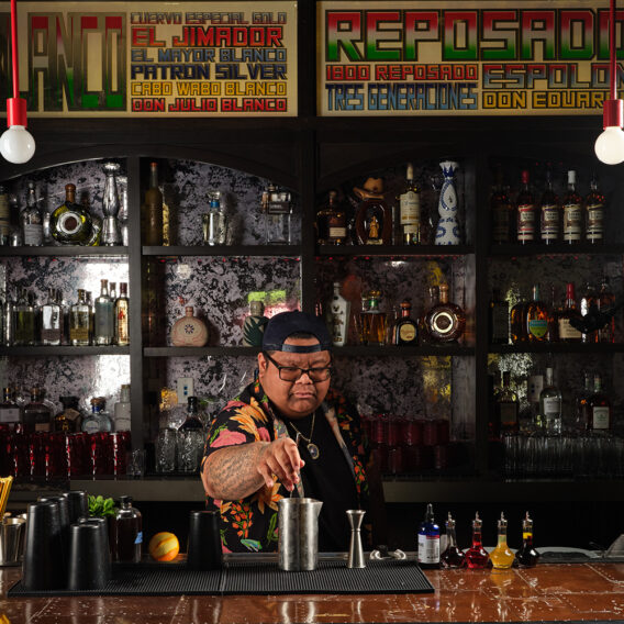 Bartender crafting cocktails behind bar
