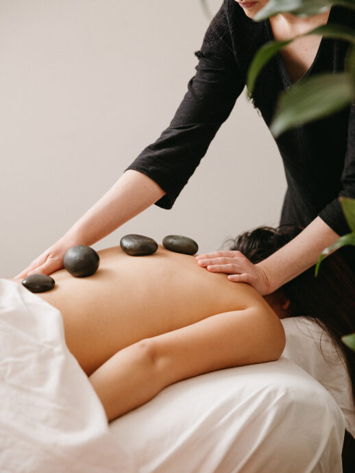 Wellness in Palm Springs: hot stone back massage in a relaxing setting with greenery.