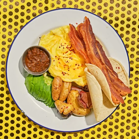 Breakfast plate with bacon and eggs, dining at Saguaro Hotel Palm Springs.