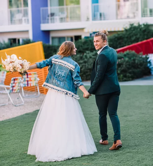 Couple walking hand-in-hand at colorful Saguaro.